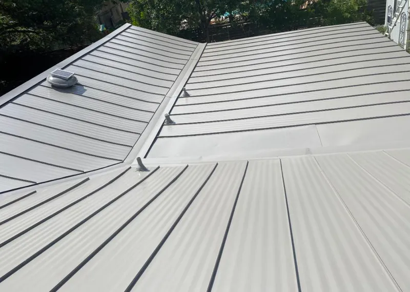 Solar attic fan installed on a metal roof for Roof Ventilation in Sparta